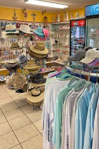 interior gift shop of Pelican Nest on Dauphin Island, Alabama with hats, t-shirts